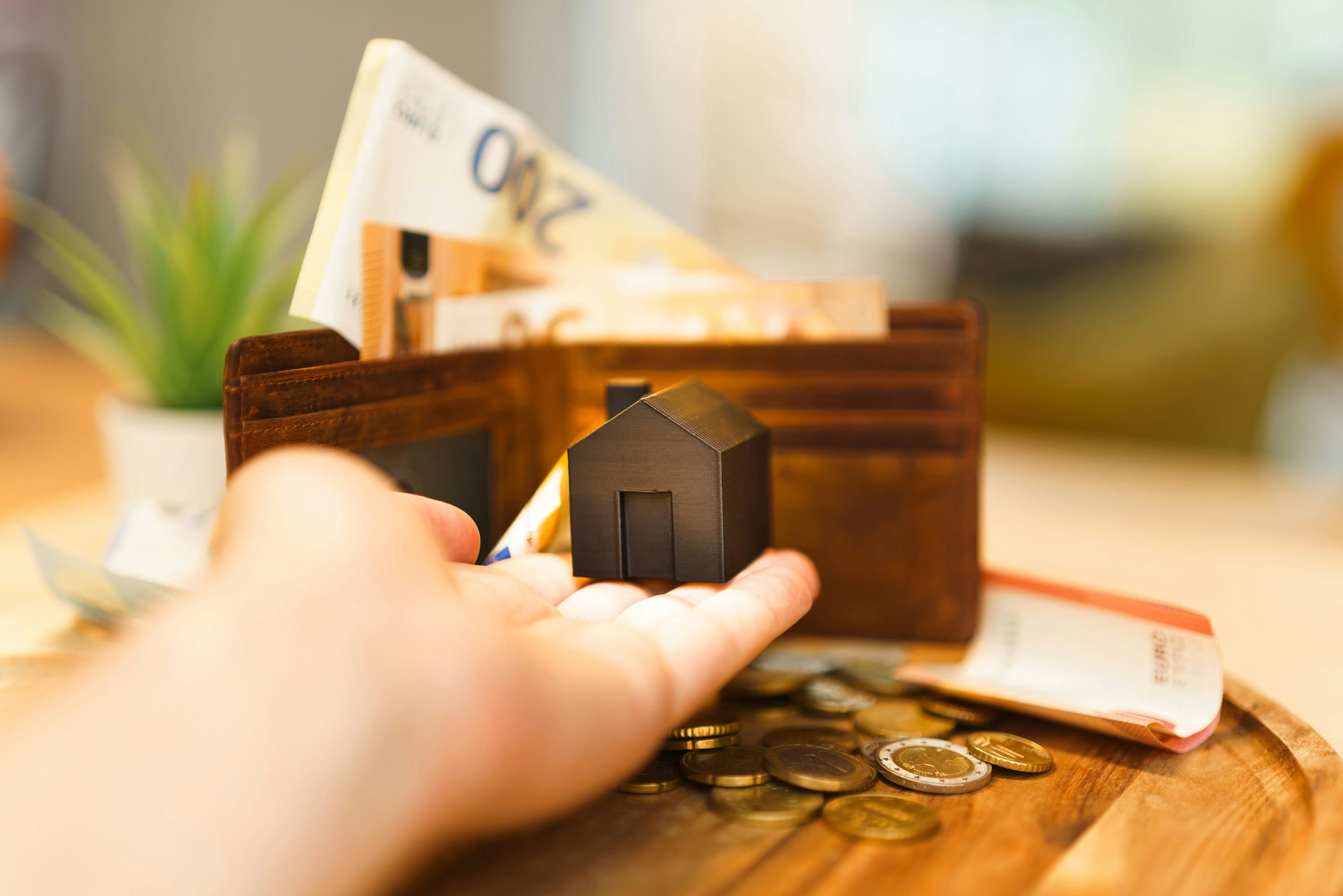 A financial calculator, legal paperwork, and house keys resting on a desk, illustrating South African property transfer costs and bond registration taxes.